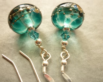 Lampwork glass earrings in teal and ink blue lampwork glass with silver decoration, on sterling silver ear wires