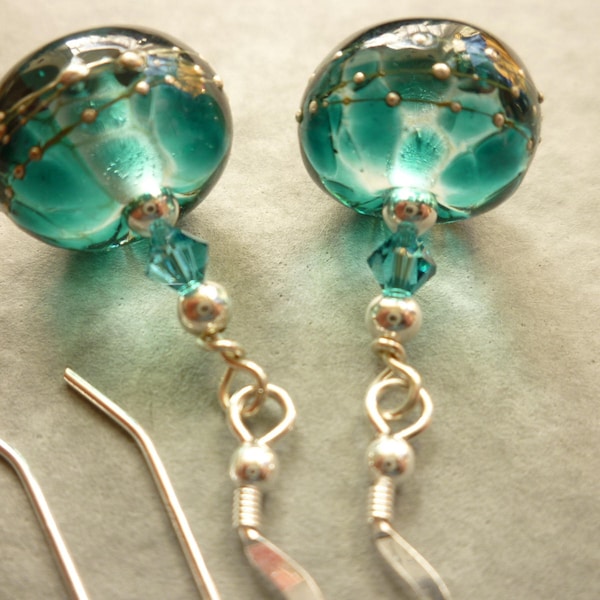 Lampwork glass earrings in teal and ink blue lampwork glass with silver decoration, on sterling silver ear wires