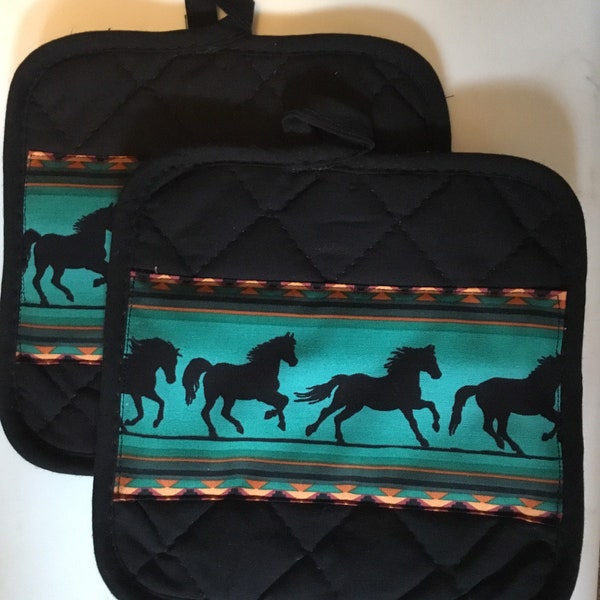 Black pot holders with turquoise horses.