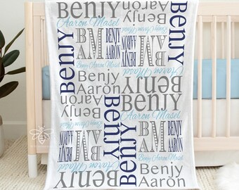 May include: White baby blanket with the names "Benjy" and "Aaron" repeated in a word cloud design. The blanket is made of minky fleece and measures 30 inches by 40 inches.