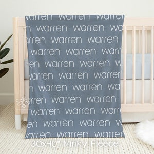 May include: A blue minky fleece baby blanket with the name "Warren" repeated in white text. The blanket is 30 inches by 40 inches.