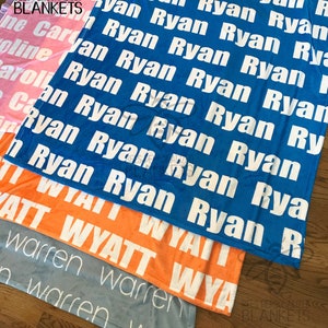 May include: A stack of personalized blankets in various colors, including blue, orange, pink, and gray. Each blanket features a name printed repeatedly in white. The brand logo "BEES PERSONALIZED BLANKETS" is visible.
