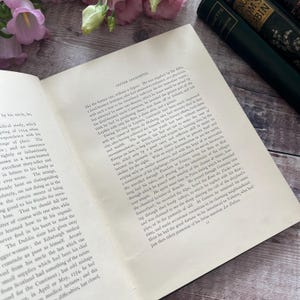 May include: A close-up of a page from a book about the life of Oliver Goldsmith. The text discusses Goldsmith's travels through Europe, including his time in France, Germany, Switzerland, and Geneva. The text mentions his use of a flute to earn money and his meeting with Voltaire.