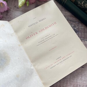 May include: A vintage book titled "The Poetical Works of Oliver Goldsmith" with a memoir by William Spalding, A.M.  The book is illustrated and published by Charles Griffin and Company in London.
