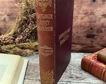 May include: A vintage hardback book titled "Northanger Abbey - Persuasion" by Jane Austen, published by Routledge. The book has a maroon spine with gold lettering and decorative accents.