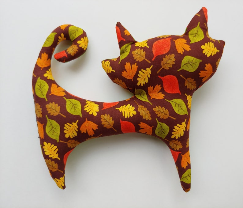 green turkeypumpkin print on front and brown autumn leaves on back Avery Stuffed Cat