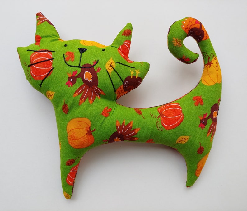 green turkeypumpkin print on front and brown autumn leaves on back Avery Stuffed Cat