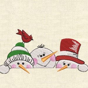 May include: Three snowmen peeking over a white surface. The snowman on the left has a green hat and a red bird on top. The snowman in the middle has a brown nose and the snowman on the right has a red hat.