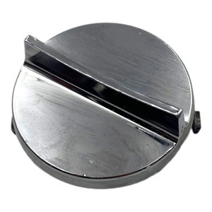 May include: A chrome-plated round cap with a single, long, rectangular slot in the centre. The cap has a slightly raised edge around the perimeter.