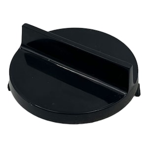 May include: Black plastic knob with a raised, flat, rectangular section. The knob is round and has a smooth surface.