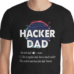 May include: Black t-shirt with a graphic design that says "Hacker Dad" with a definition of the term. The graphic design is in a pixelated style with blue, pink, and white colors.