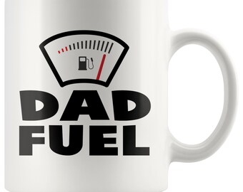 May include: White ceramic coffee mug with a black and red fuel gauge graphic and the text "DAD FUEL" in black.