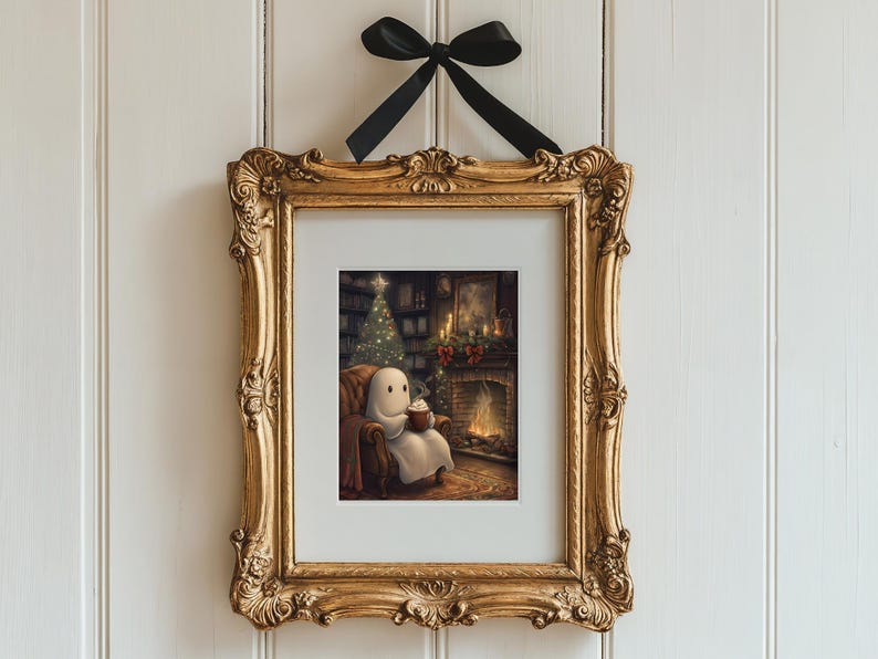 May include: A framed illustration of a ghost sitting in a chair by a fireplace with a mug in its hands. The ghost is white and has a simple face. The fireplace is lit and there is a Christmas tree in the background.