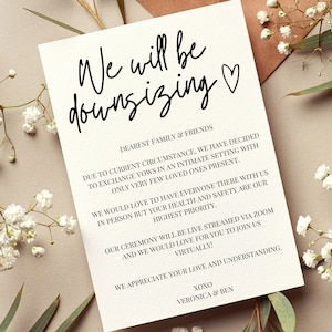 May include: A wedding announcement card with the text "We will be downsizing" and a small heart symbol. The card explains that due to current circumstances, the wedding will be a small, intimate ceremony with only a few loved ones present. The ceremony will be live-streamed via Zoom, and guests are invited to join virtually. The card concludes with "We appreciate your love and understanding." and is signed "XOXO, Veronica & Ben."