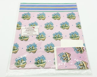 May include: A pink wrapping paper with a mushroom and flower pattern. The paper is packaged with a matching gift tag. The text on the package reads "Mushrooms" and "Current Designs".