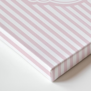 May include: A canvas print featuring a diagonal pattern of pink and white stripes. The edges of the canvas reveal the wooden frame. The print is a close-up shot, highlighting the texture and design.