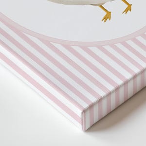 May include: A canvas art print featuring a watercolor illustration of a goose. The artwork is set within a pink and white striped border. The canvas edges are also covered in the pink and white stripe pattern.