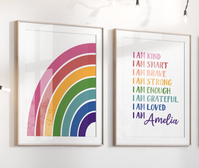 May include: Two framed prints, one with a rainbow arc in shades of pink, red, orange, yellow, green, blue, and purple, and the other with the text "I am kind, I am smart, I am brave, I am strong, I am enough, I am grateful, I am loved, I am Amelia" in rainbow colours.