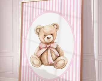 May include: A framed print with a pink and white striped background. A brown teddy bear with a pink bow sits in the center of a white circle.