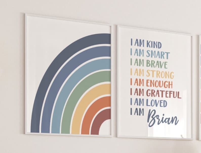 May include: Two framed prints featuring a rainbow design and positive affirmations. The left print shows a colourful rainbow arc. The right print has the text "I am kind, I am smart, I am brave, I am strong, I am enough, I am grateful, I am loved, I am Brian".