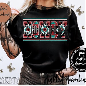 Może przedstawiać: Czarny T-shirt z czerwono-biało-niebieskim wzorem geometrycznym, na którym widnieje napis "HOWDY" w stylu południowo-zachodnim.