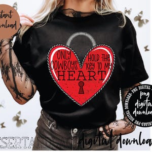 May include: Black t-shirt with a red heart graphic and the text "Only Cowboys Hold the Key to My Heart".