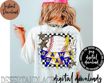May include: A white t-shirt featuring a graphic design of a baseball with a lightning bolt and a banner that reads "Game Day". The baseball is yellow and blue with white stitching. The banner is yellow with blue lettering. The background is a checkered pattern.