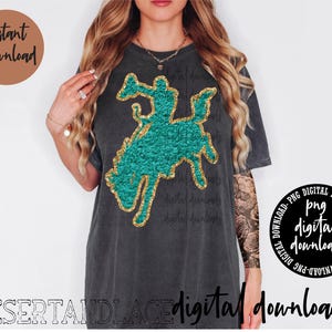 May include: Dark gray t-shirt featuring a turquoise and gold glitter rodeo rider graphic. The shirt has the text "digital downloads" and "Instant Download" on it. The shirt is a digital download.