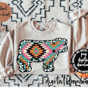 May include: A digital download of a cow graphic with a geometric pattern in pink, orange, blue, and black. The cow is outlined in black with white spots. The graphic is on a beige sweatshirt.
