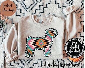 May include: A digital download of a graphic design featuring a goat with a geometric pattern in shades of pink, blue, orange, and black. The goat is outlined in black and has a white and black leopard print pattern on its body. The design is on a beige sweatshirt.