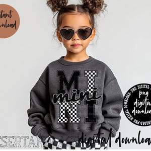 Op de afbeelding: Een zwart sweatshirt met een wit en zwart geruit ontwerp met de tekst "M mini N" op de voorkant. Het sweatshirt wordt gedragen door een kind met zwart haar en hartvormige zonnebrillen.