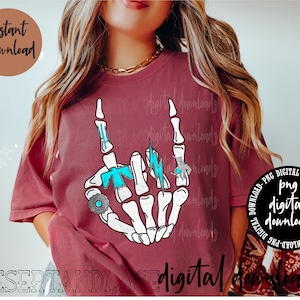 May include: A maroon t-shirt featuring a skeleton hand making a rock-and-roll gesture. The hand is adorned with turquoise and silver rings and a lightning bolt. The words "Instant Download" and "Digital Downloads" are also visible.