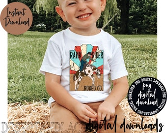 May include: A white t-shirt with a vintage-style graphic of a cowboy riding a bucking horse. The graphic includes the text "Rank Rider Rodeo Co."