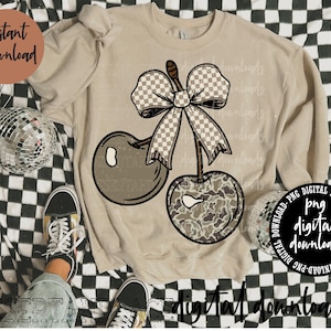 May include: Beige sweatshirt with a cherry design, a checkered bow, and camouflage-patterned cherries. The words "Instant Download" are in a brown circle. The words "digital downloads" are at the bottom.