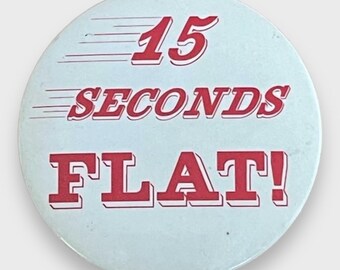 May include: A circular, pale blue badge featuring the text "15 SECONDS FLAT!" in red, bold lettering with a white outline. Speed lines are above the text, giving a sense of motion.