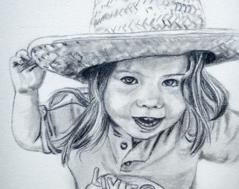 May include: A black and white pencil drawing of a young girl wearing a straw hat and a shirt with a graphic design. The girl is smiling and looking at the camera.