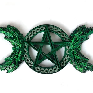 May include: A green pentagram with a triple moon symbol on either side. The pentagram is surrounded by a circle of Celtic knotwork.