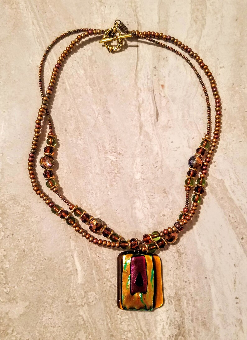 2SF Peg Montana Dichroic Glass necklace in burgundy green and iris with dichroic pendant 2 beaded strands.
