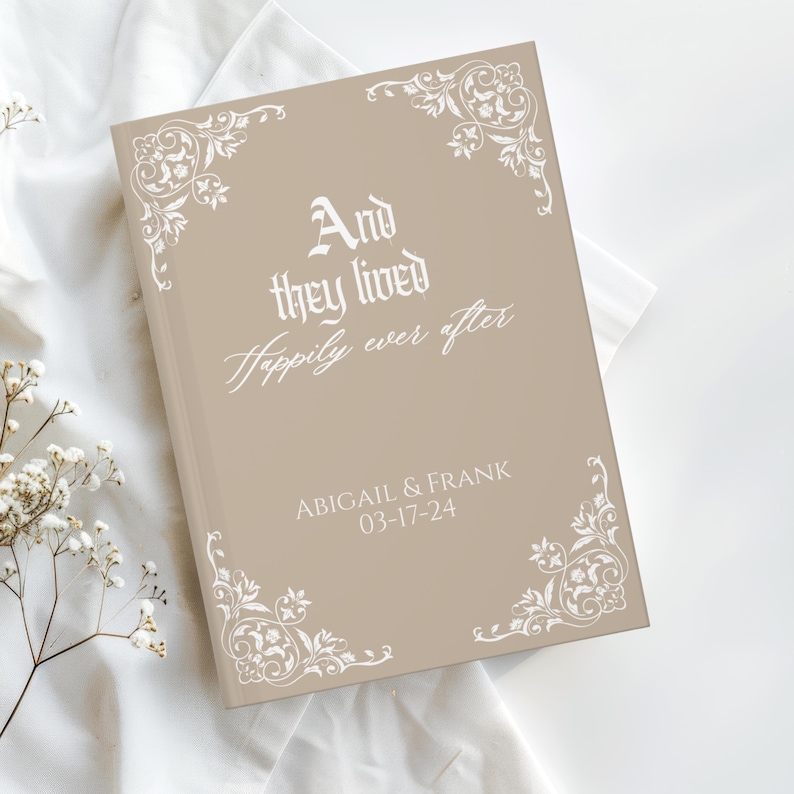 May include: A tan-colored wedding guest book with white floral corner designs and the text "And they lived Happily ever after." The names "ABIGAIL & FRANK" and the date "03-17-24" are also printed on the cover.
