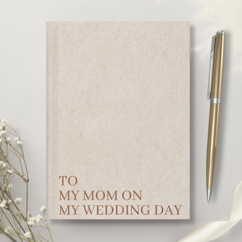 May include: A beige journal with the text "TO MY MOM ON MY WEDDING DAY" printed in brown on the front cover.