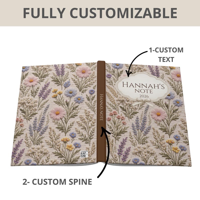 May include: Open notebook with a floral design featuring pink, purple, and yellow flowers on a beige background. The text "Hannah's Note 2026" is displayed on the cover. The spine is brown and labeled "Hannah's Note". The text "FULLY CUSTOMIZABLE" is at the top.