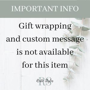 May include: A white wooden sign with black text that reads "IMPORTANT INFO" and "Gift wrapping and custom message is not available for this item". The sign is decorated with green eucalyptus leaves.