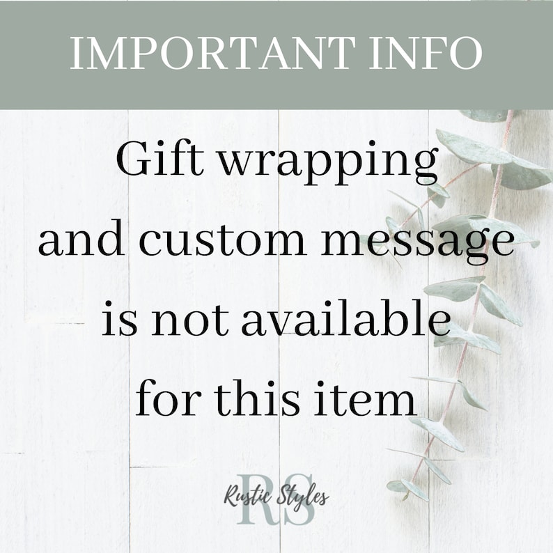 May include: A white wooden sign with the text "IMPORTANT INFO" in black lettering. The sign also includes the text "Gift wrapping and custom message is not available for this item" in black lettering. The sign is decorated with eucalyptus leaves.