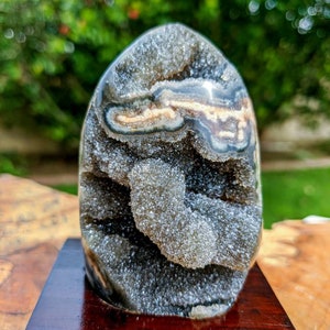 Uruguay amethyst grey black stalactite formation geode display on wood base stand, polish edge jasper and agate