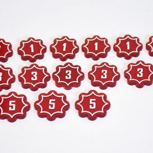 May include: A set of 15 red plastic game tokens with white numbers. The numbers are 1, 3, and 5.