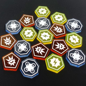 May include: A collection of 15 hexagonal game tokens with various symbols and colors. The tokens are made of clear plastic with a white design. The symbols include a lightning bolt, a drone, and a crown.