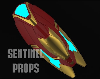May include: A red and gold futuristic weapon with a blue glowing light. The weapon is shaped like a boomerang with a pointed tip. The text "SENTINEL PROPS" is visible in the lower left corner of the image.