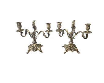 Antique pair of rococo candlesticks in gilded bronze
