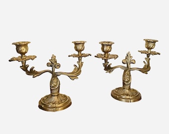 Antique pair of rococo candlesticks in gilded bronze