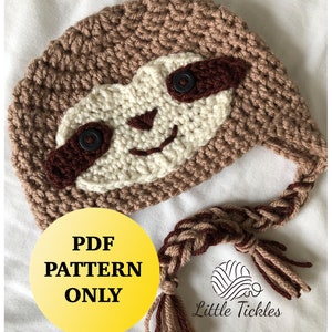 May include: A crochet sloth hat pattern in PDF format. The hat is brown with a white face and brown eyes. The hat has a long brown and white braided tail with tassels.